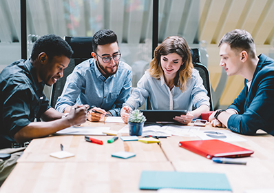 Multicultural,Group,Of,Professional,Designers,Collaborating,On,Task,Using,Modern