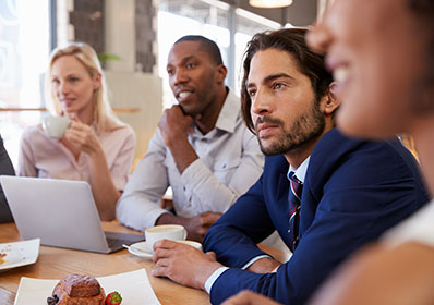 Group,Of,Businesspeople,Having,Meeting,In,Coffee,Shop